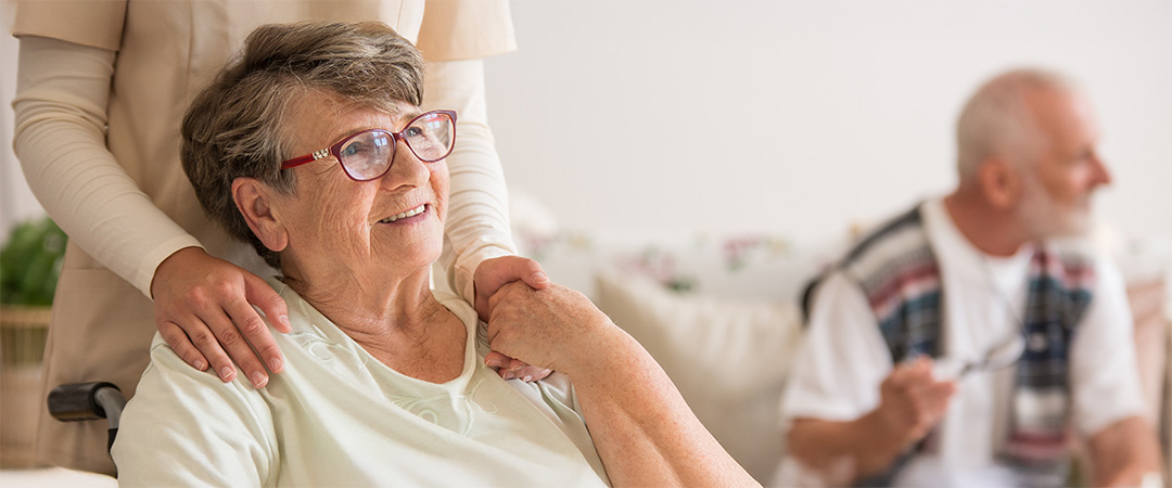 A woman holding hands with a care giver